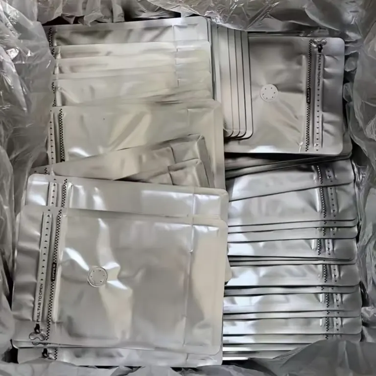 Multiple silver coffee pouch samples with degassing valves